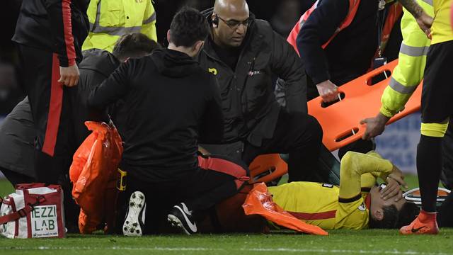 Watford's Mauro Zarate receives medical attention after sustaining an injury