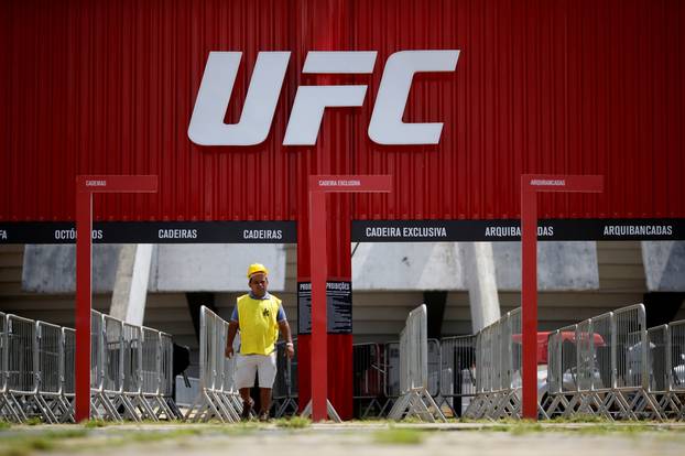 A man walks in front of the Nilson Nelson Gymnasium as the next UFC Fight Night will be held without fans during the fights, after reports of the coronavirus in Brasilia