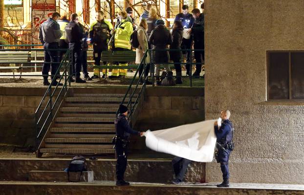 Police cover a body after a shooting outside an Islamic center in central Zurich