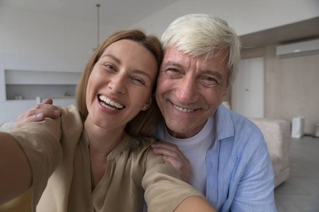 Cheerful senior dad and adult daughter child having fun