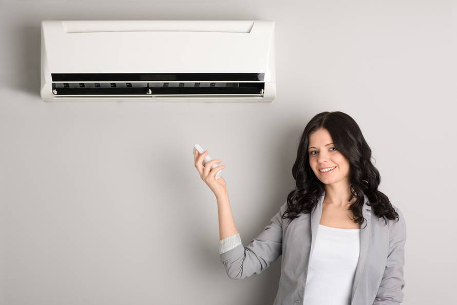 Beautiful,Girl,Holding,A,Remote,Control,Air,Conditioner