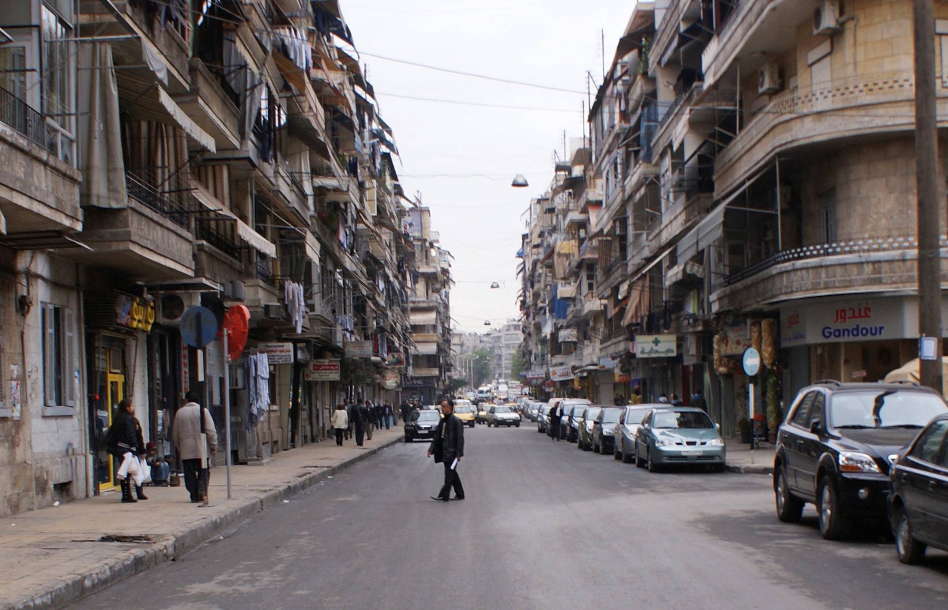 A man crosses a street in Aleppo