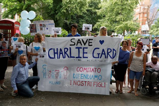 Supporters of the the parents of critically ill baby Charlie Gard hold a banner before handing in a petition to Great Ormond Street Hospital, in central London