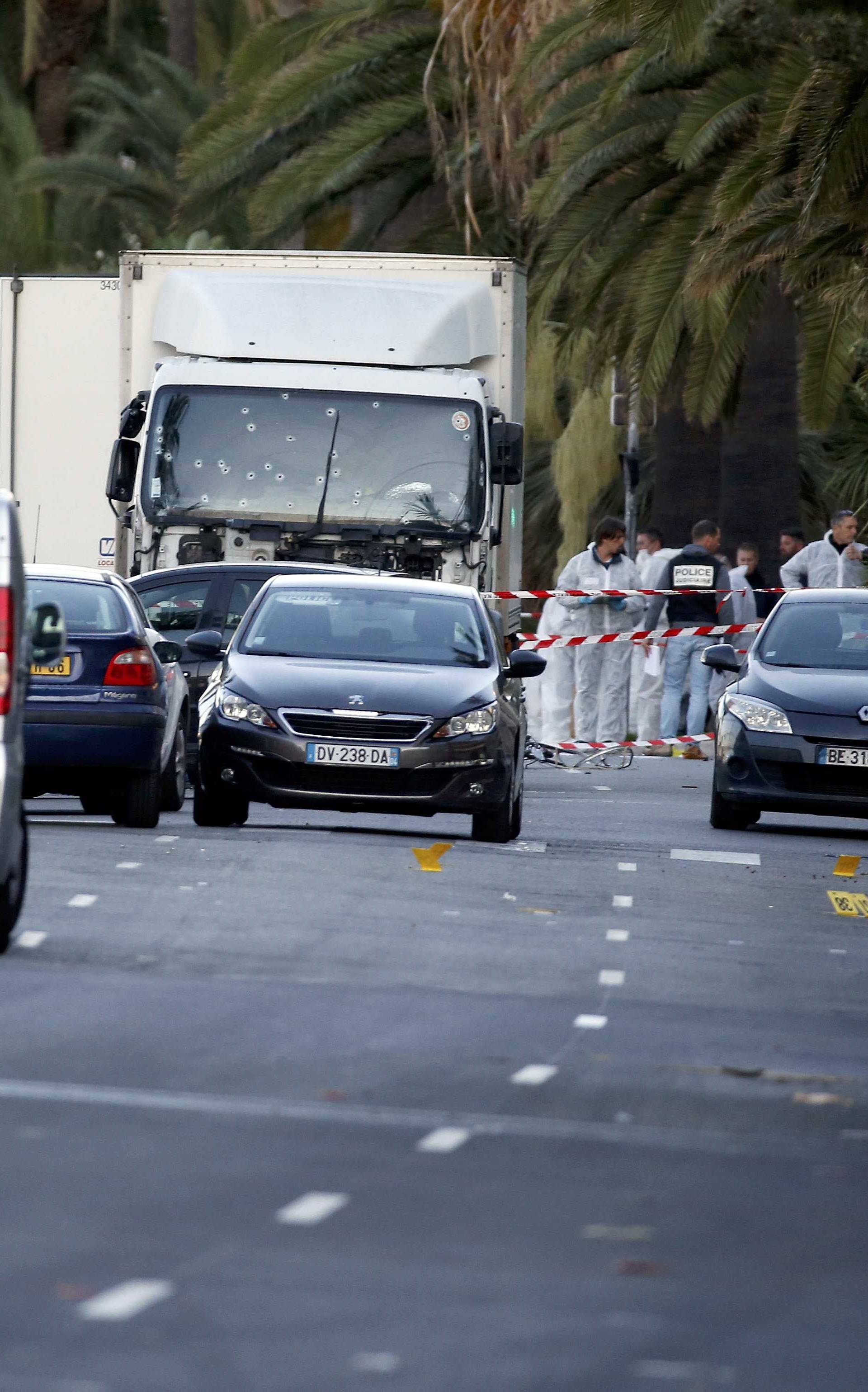 French CRS and judicial police work near the heavy truck that ran into a crowd at high speed celebrating the Bastille Day July 14 national holiday on the Promenade des Anglais killing 80 people in Nice