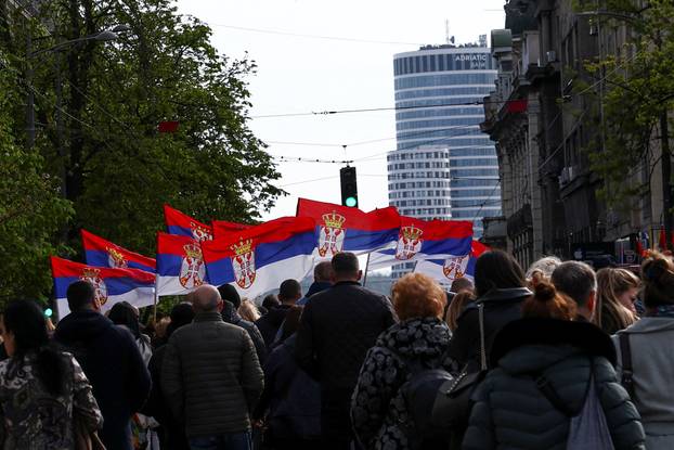 People attend a rally in support of policies of the President Aleksandar Vucic