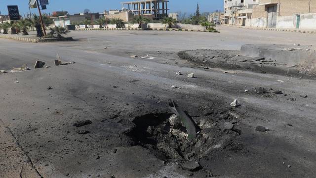 FILE PHOTO: A crater is seen at the site of an airstrike, after what rescue workers described as a suspected gas attack in the town of Khan Sheikhoun