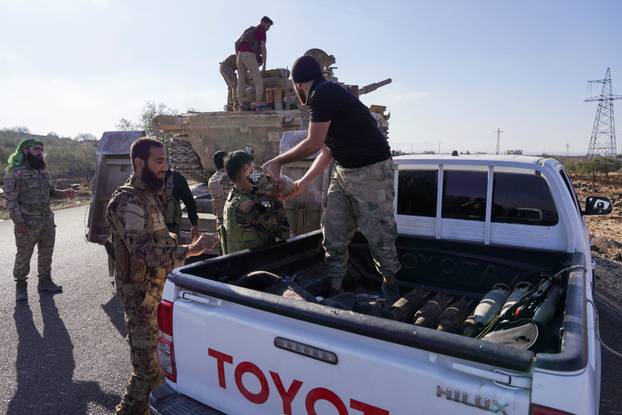 A member of Syrian security forces holds a weapon as he stands at a back of a truck after Syrian troops entered the predominantly Druze city of Sweida