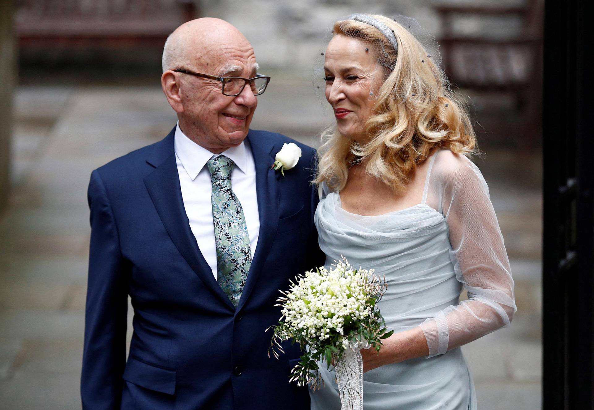 FILE PHOTO: Media Mogul Rupert Murdoch and former supermodel Jerry Hall pose for a photograph outside St Bride's church following a service to celebrate their wedding which took place on Friday, in London