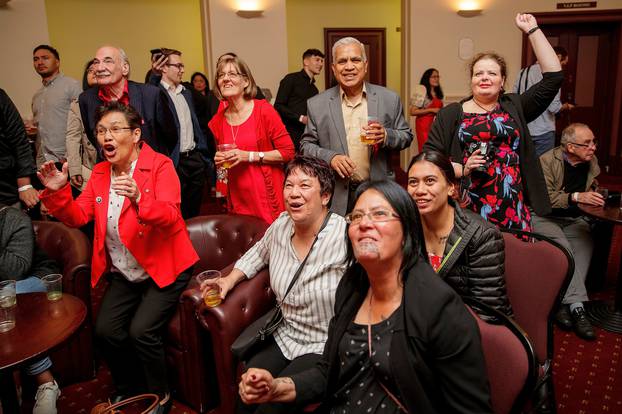 Labour Party supporters cheer as they watch reports of early results in Auckland