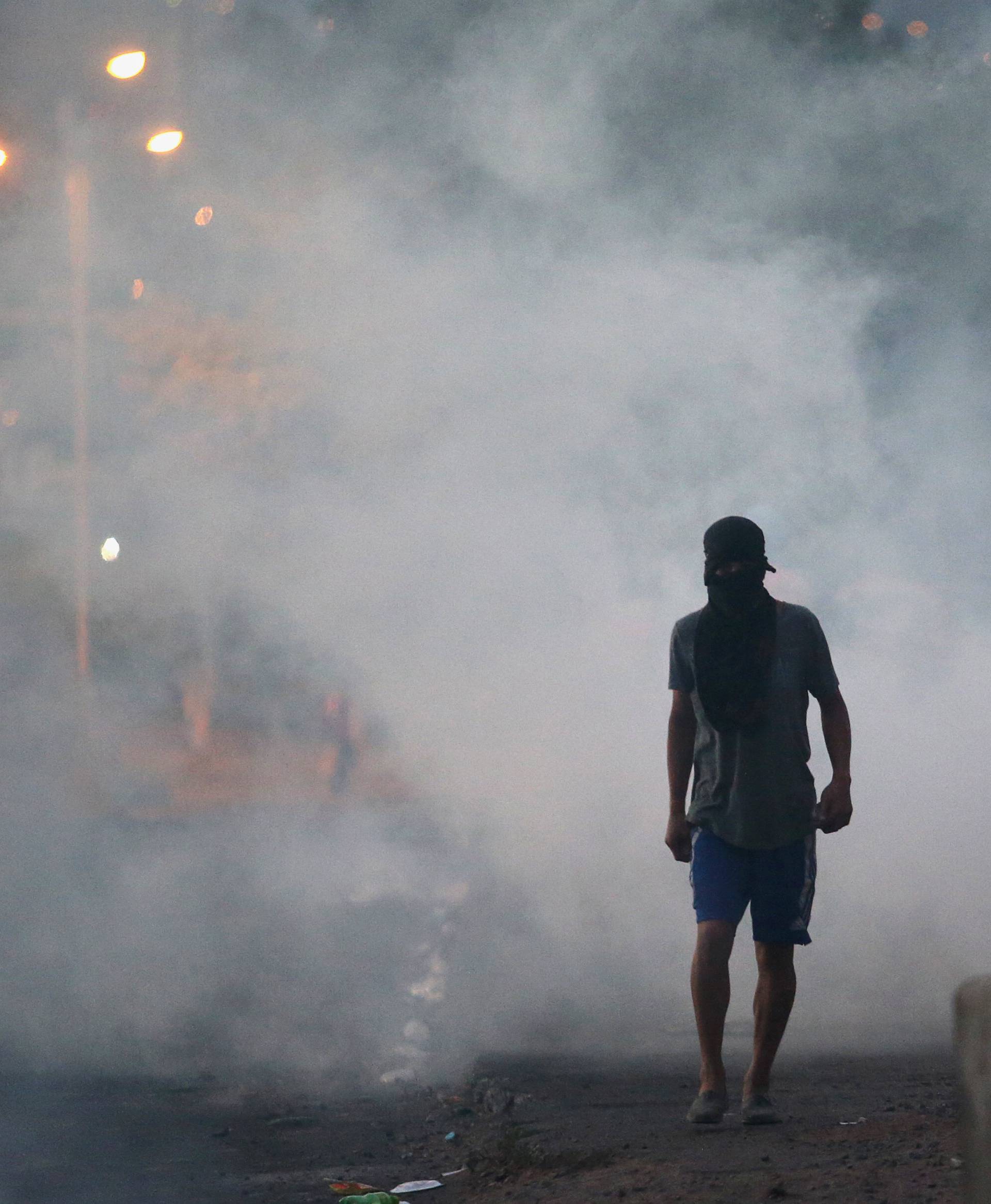 A supporter of presidential candidate Salvador Nasralla walks on a street during a protest caused by the delayed vote count for the presidential election at Villanueva neighborhood in Tegucigalpa