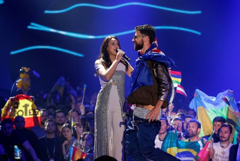 Ukraine's Jamala performs a song as a fan attempts to show his buttocks during the grand final of the Eurovision Song Contest 2017 at the International Exhibition Centre in Kiev