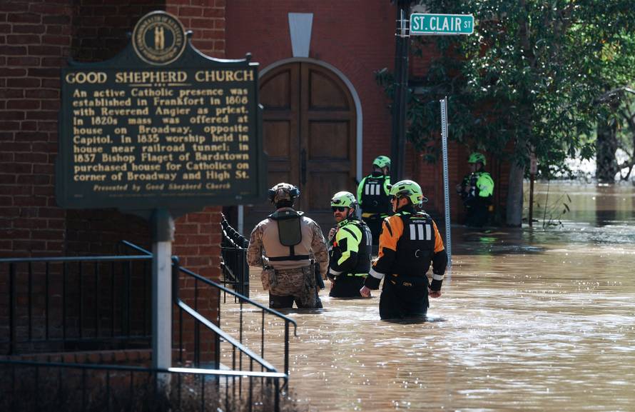 FEMA officials wade through flood waters in Frankfort