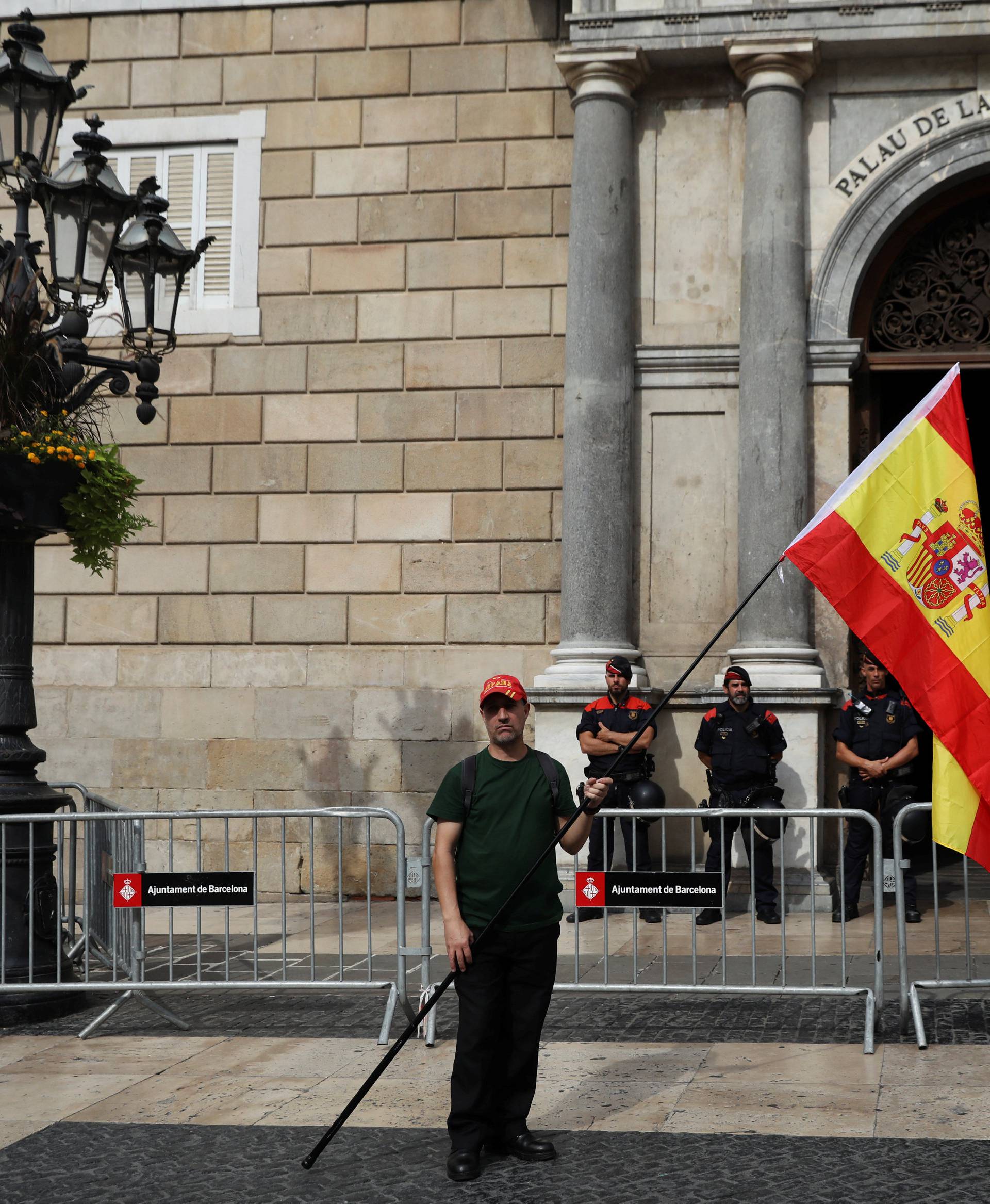 A man holds up a Spanish during a demonstration in favor of a unified Spain a day before the banned October 1 independence referendum in Barcelona