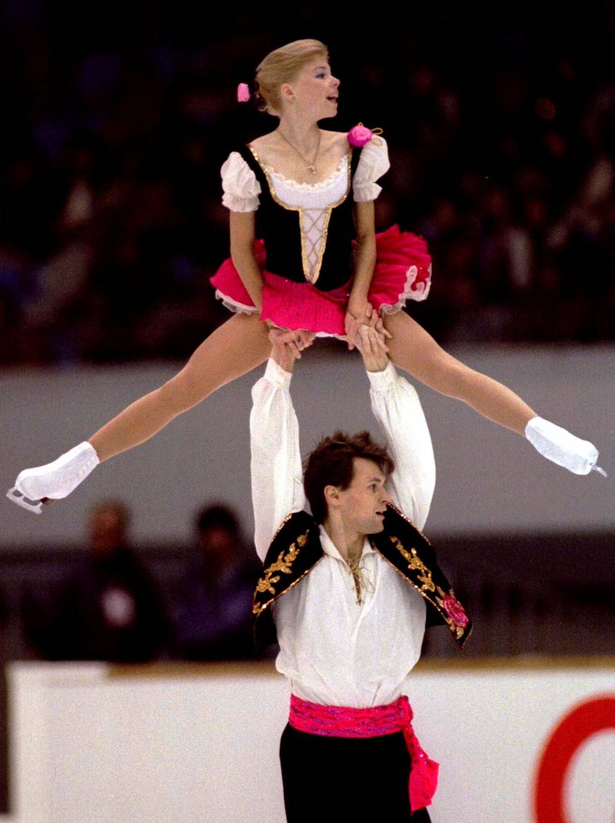 FILE PHOTO: Russia's Vadim Naumov lifts up his partner Evgenia Shishkova during the free skating to win the pairs event of the NHK Trophy figure skating grand prix in Nagoya