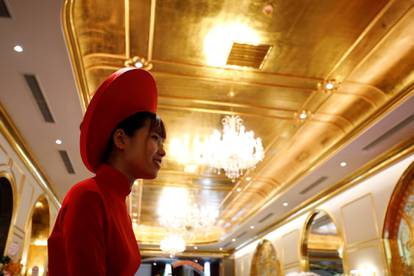 An employee in traditional dress is seen in the newly-inaugurated Dolce Hanoi Golden Lake luxury hotel, after the government eased a nationwide lockdown following the global outbreak of the coronavirus disease (COVID-19), in Hanoi