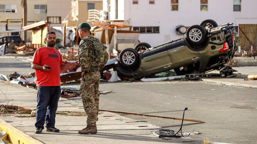 A Royal Marine is seen speaking to a local resident in Tortola, British Virgin Islands