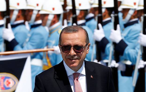 Turkish President Tayyip Erdogan reviews a guard of honour during a welcoming ceremony at the Presidential Palace in Ankara