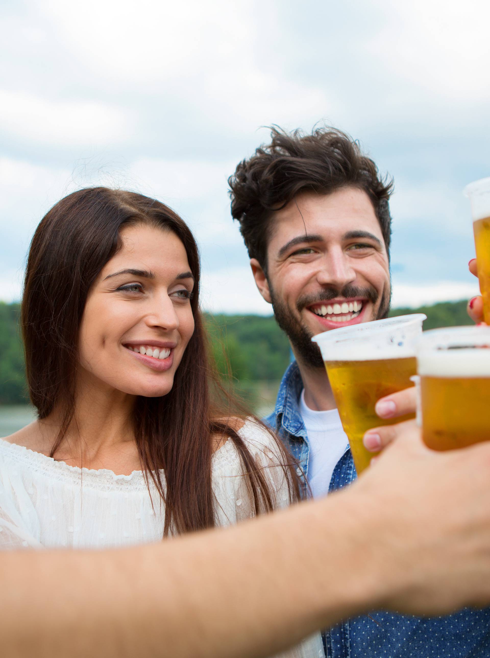 Group of friends holding beers and making a toast