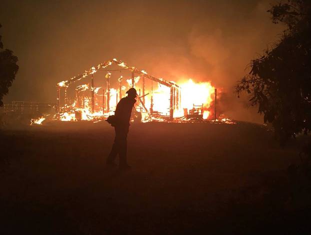 A wildfire burns a structure in Goleta