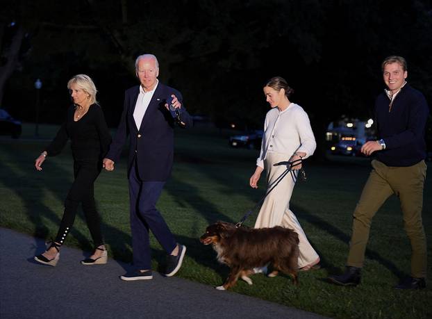 FILE PHOTO: U.S. President Joe Biden, First lady Jill Biden, their granddaughter Naomi Biden and her fiance Peter Neal walk from Marine One upon arrival to the White House