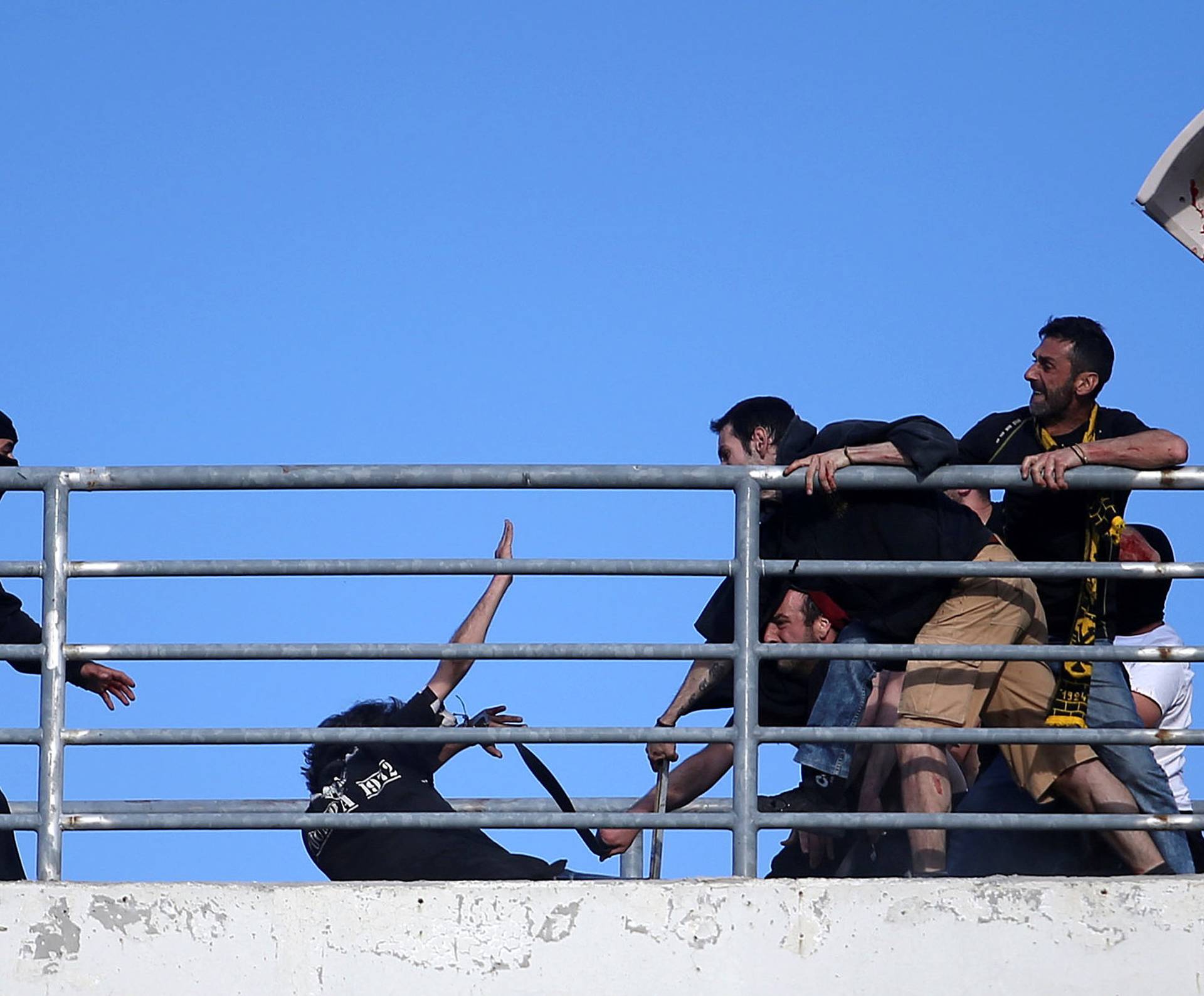 Fans of PAOK Salonika and AEK Athens clash before the Greek Cup Final soccer game at Panthessaliko stadium in Volos