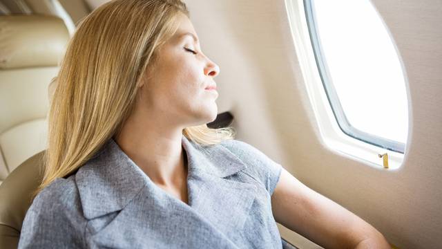 Businesswoman Sleeping In Private Jet