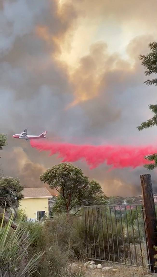 A Boeing 747 airtanker drops retardant on the Valley Fire in San Diego county, California