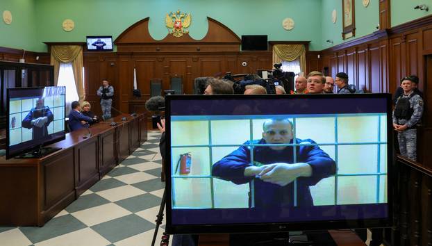 FILE PHOTO: Jailed Russian opposition leader Alexei Navalny is seen on screens during a court hearing in Moscow