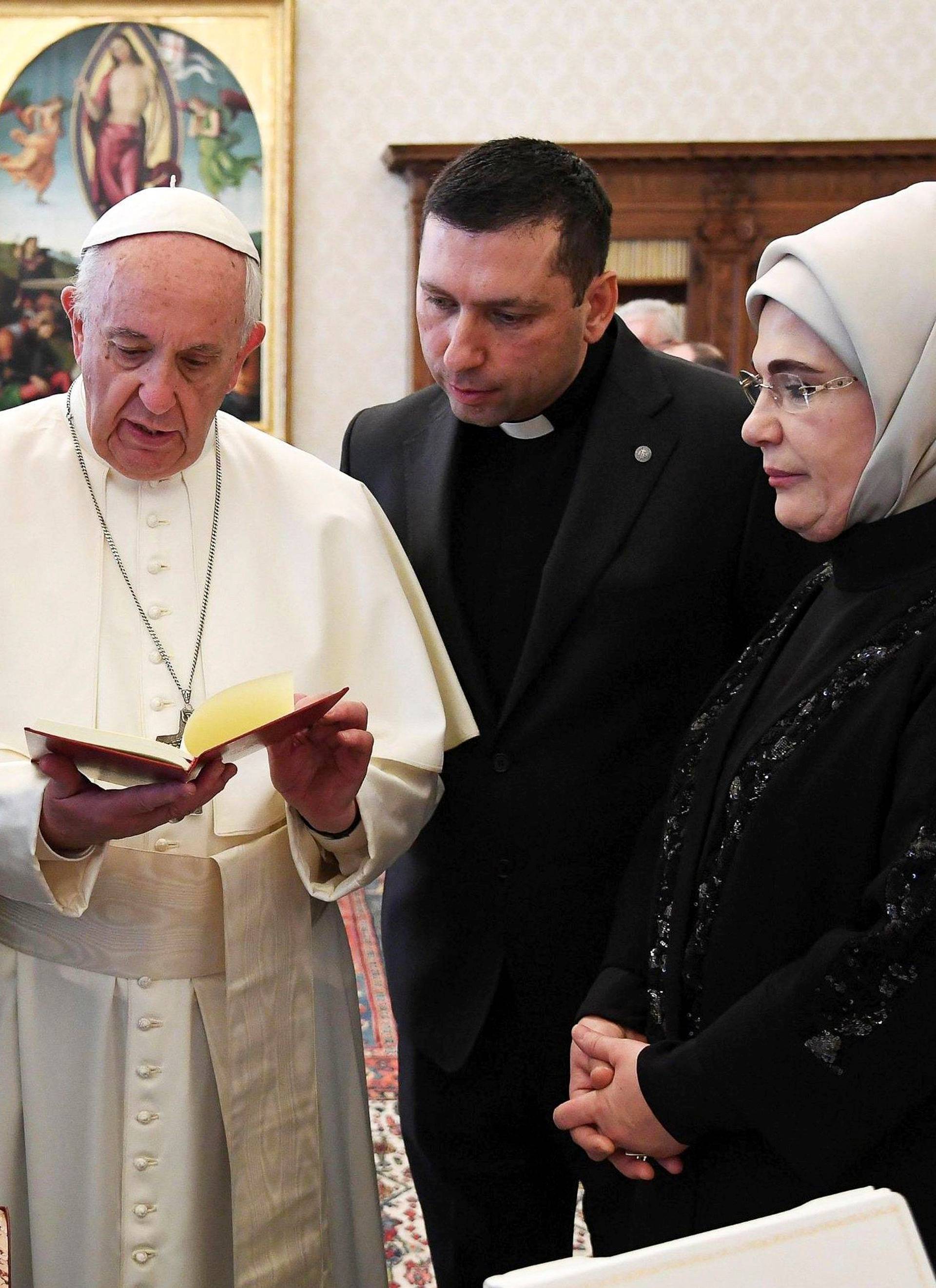 Pope Francis exchanges gift with Turkish President Tayyip Erdogan and his wife Emine during a private audience at the Vatican