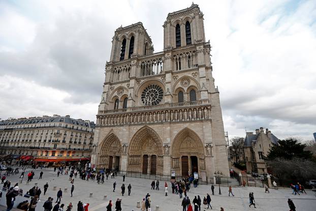 FILE PHOTO: People walk past the entrance to the Notre Dame Cathedral in Paris