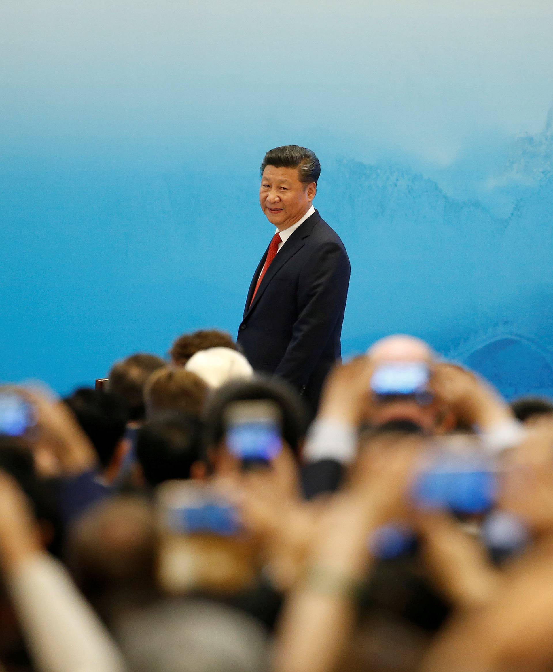 FILE PHOTO: China's President Xi Jinping arrives for the opening ceremony of B20 Summit ahead of G20 Summit, in Hangzhou