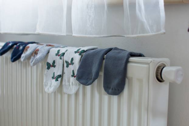 Socks,Are,Drying,On,Radiator,At,Home.,Save,Energy,And