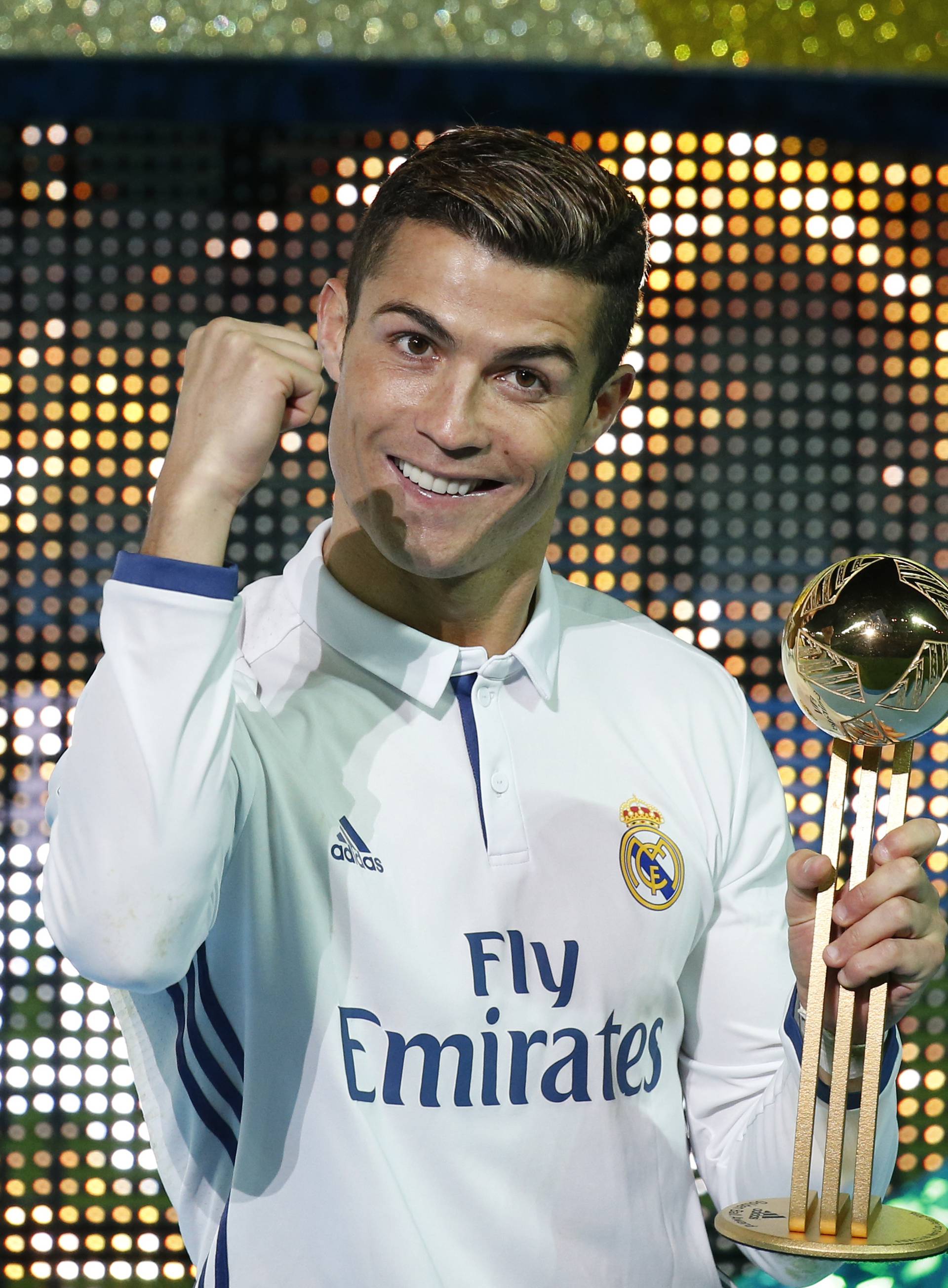 Real Madrid's Cristiano Ronaldo celebrates with the Golden Ball trophy