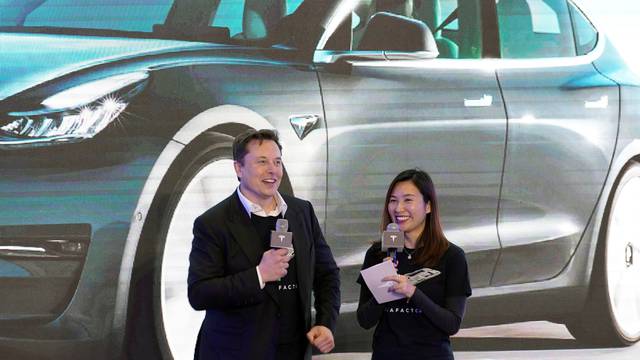 Tesla Inc's Elon Musk and Grace Tao attend a delivery ceremony for the EV maker's China-made Model 3 cars in Shanghai