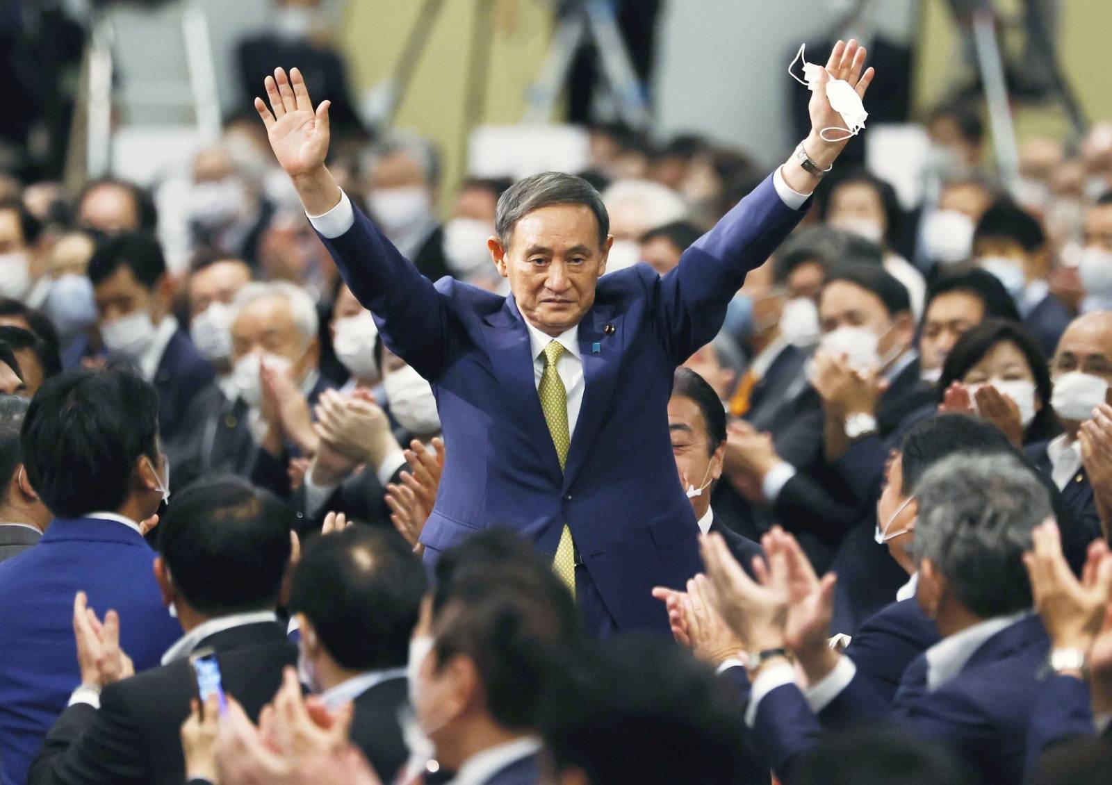 Japanese Chief Cabinet Secretary Suga gestures as he is elected as new head of the ruling party at the Liberal Democratic Party's (LDP) leadership election in Tokyo