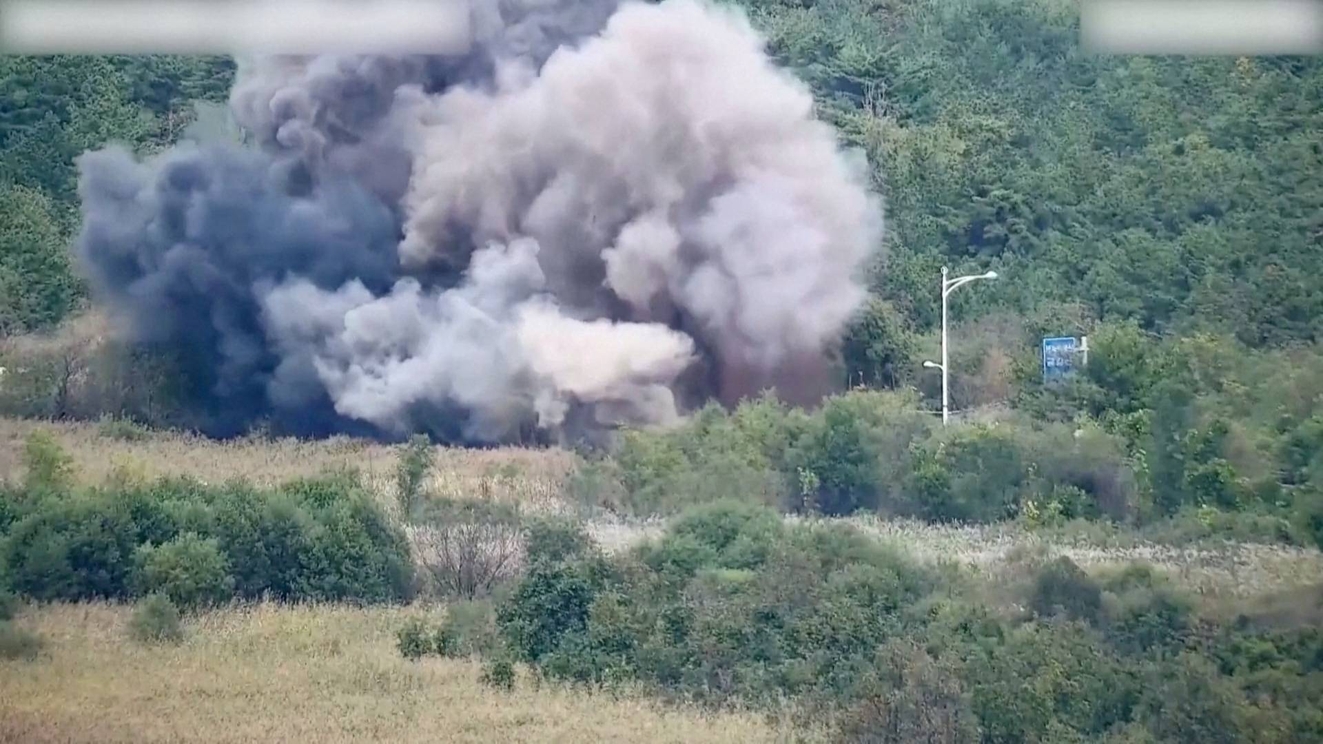 Smoke after North Korea blows up sections of inter-Korean roads on its side of the border between the two Koreas, as seen from the South Korean side