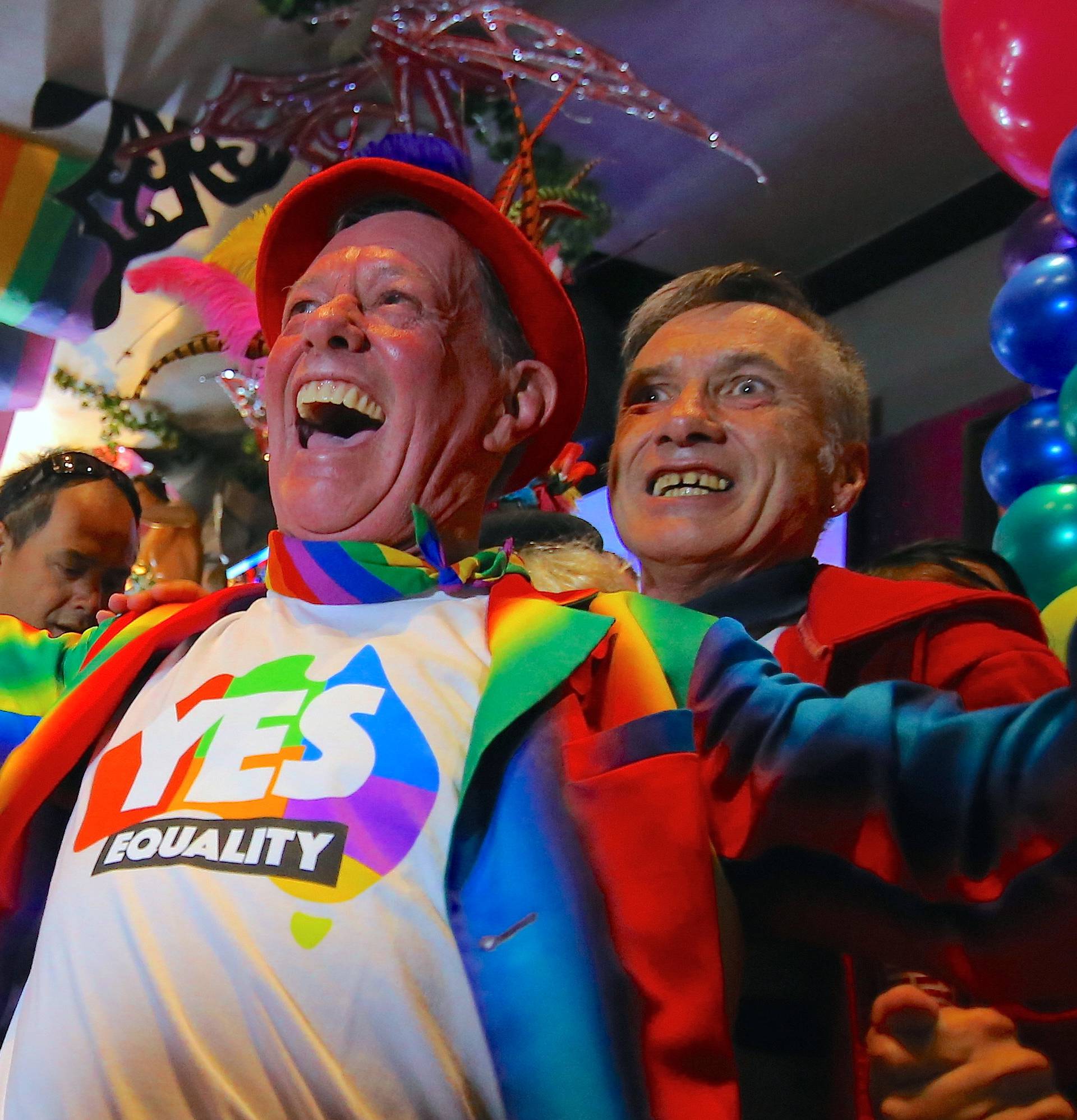 Members of the Sydney's gay community react as they celebrate after it was announced the majority of Australians support same-sex marriage in a national survey, at a pub located on Sydney's Oxford street