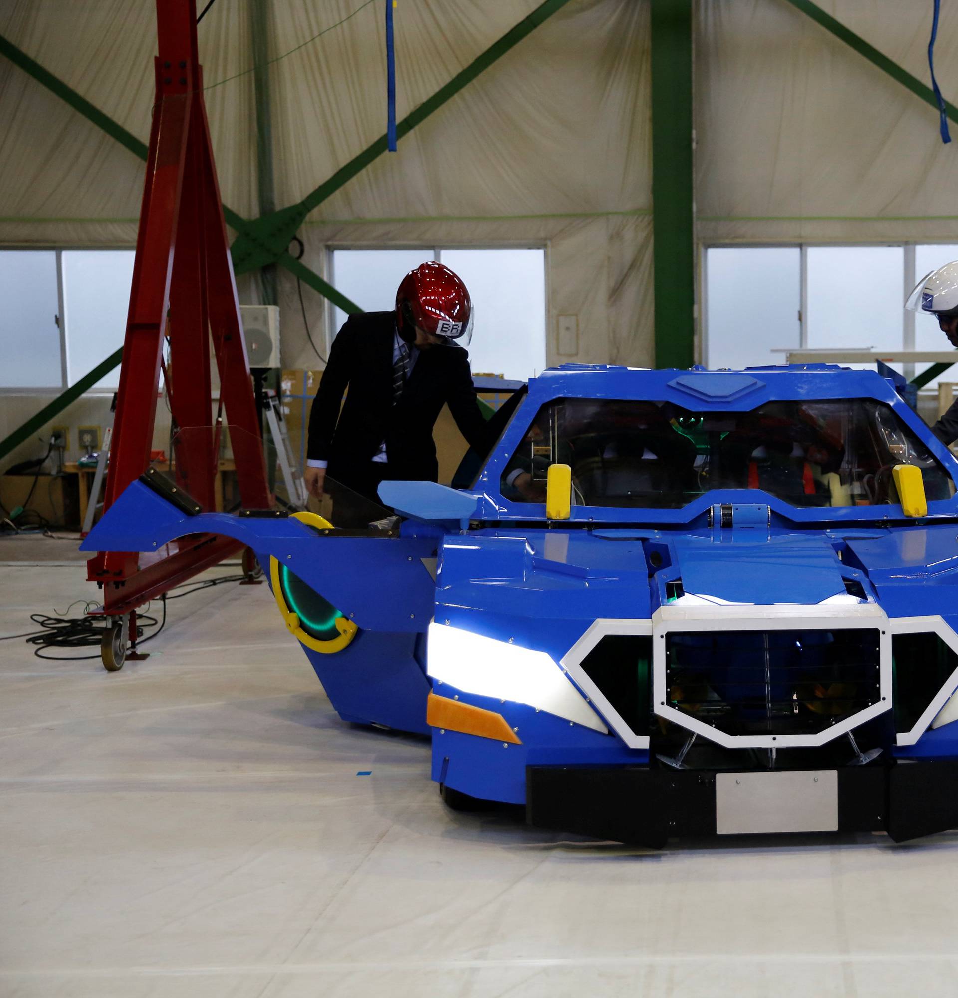 New transforming robot called "J-deite RIDE" that transforms itself into a passenger vehicle, developed by Brave Robotics Inc, Asratec Corp and Sansei Technologies Inc, demonstrates during its unveiling at a factory near Tokyo