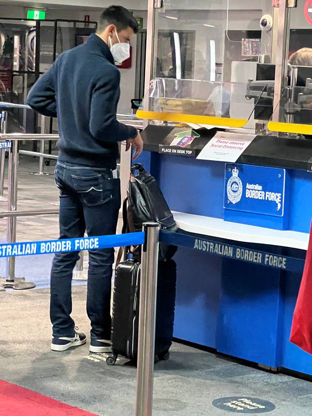 Serbian tennis player Novak Djokovic stands at a booth of the Australian Border Force at the airport in Melbourne