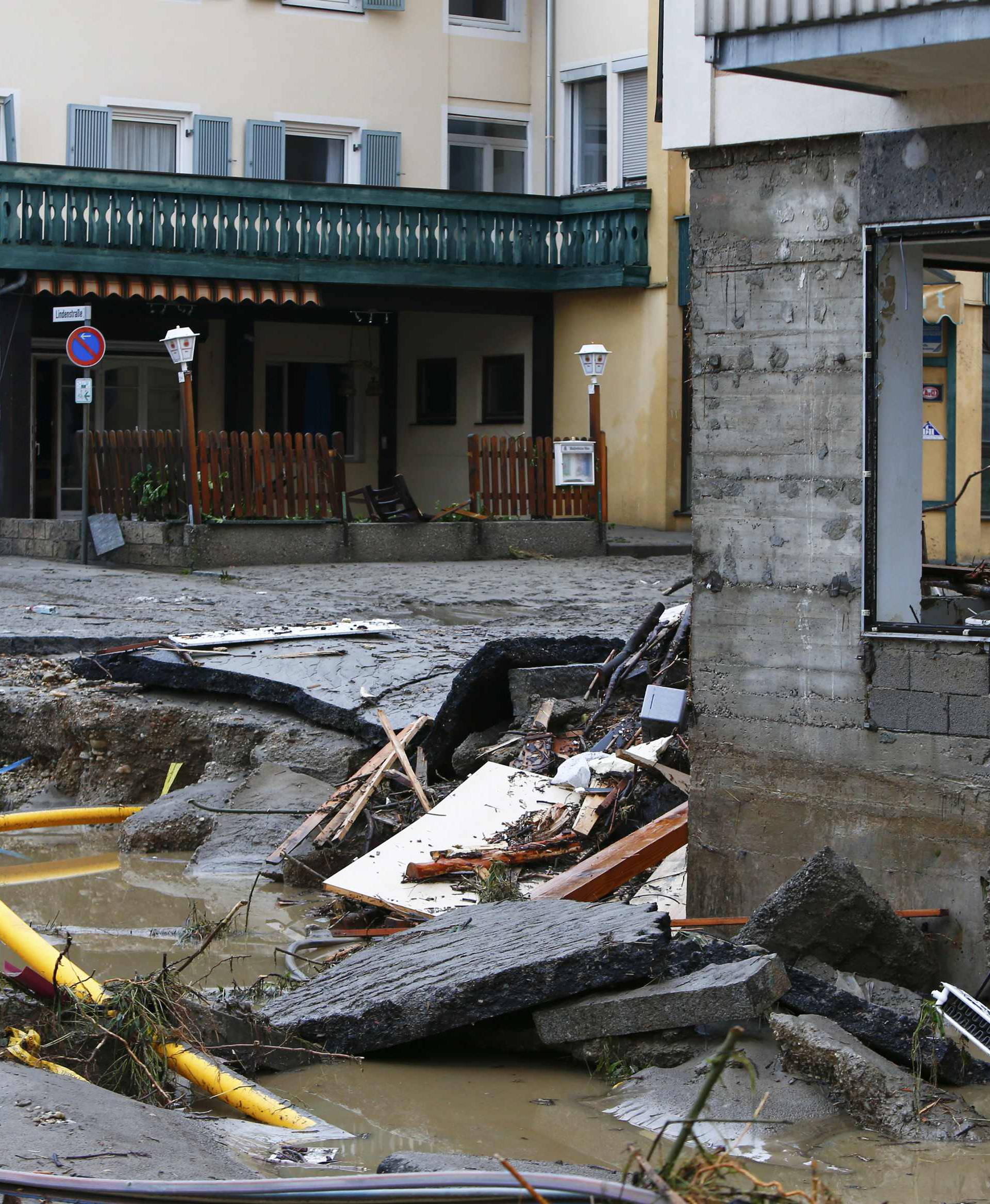 People stand in the street damaged by floods in the Bavarian village of Simbach am Inn