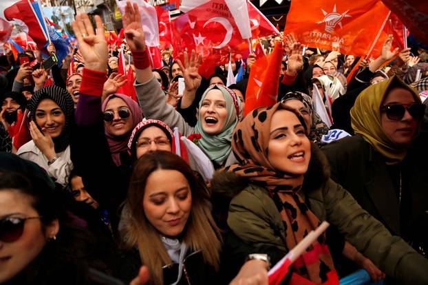 Supporters of Turkish President Erdogan cheer during a rally for the upcoming local elections in Istanbul