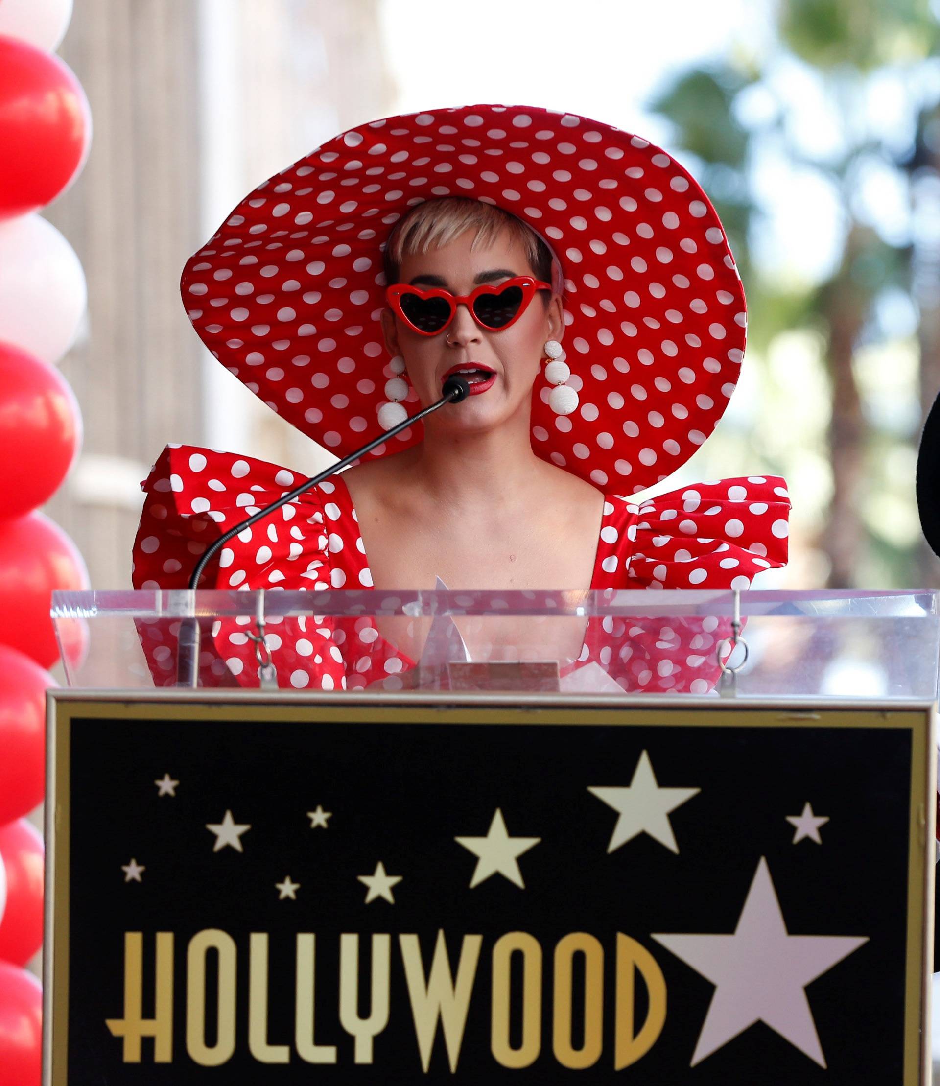 Singer Perry speaks next to the character of Minnie Mouse at the unveiling of her star on the Hollywood Walk of Fame in Los Angeles