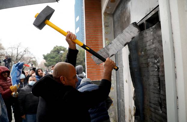 Protesters attack the headquarters of the Democratic Party in Tirana