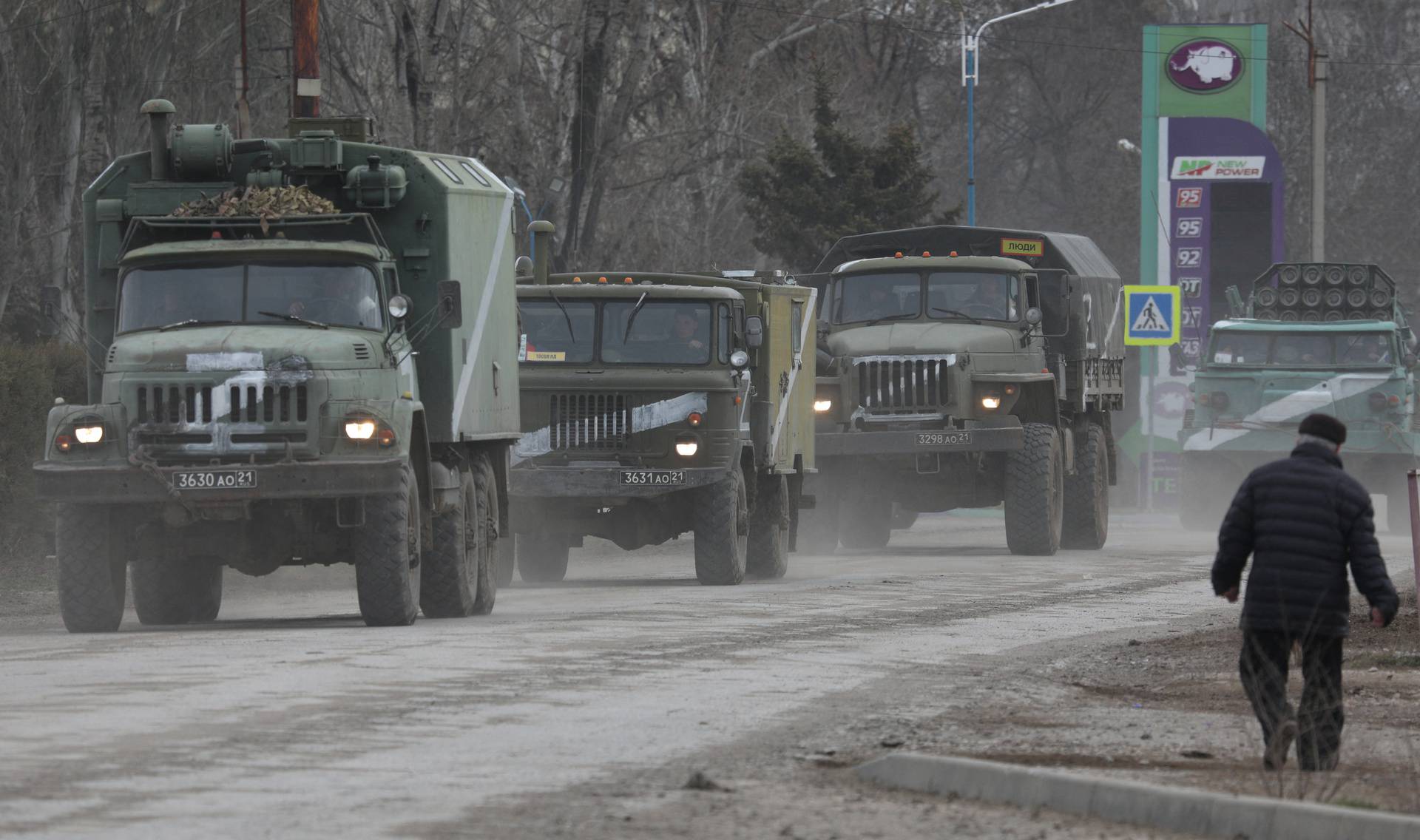 Russian Army military vehicles drive along a street in Armyansk