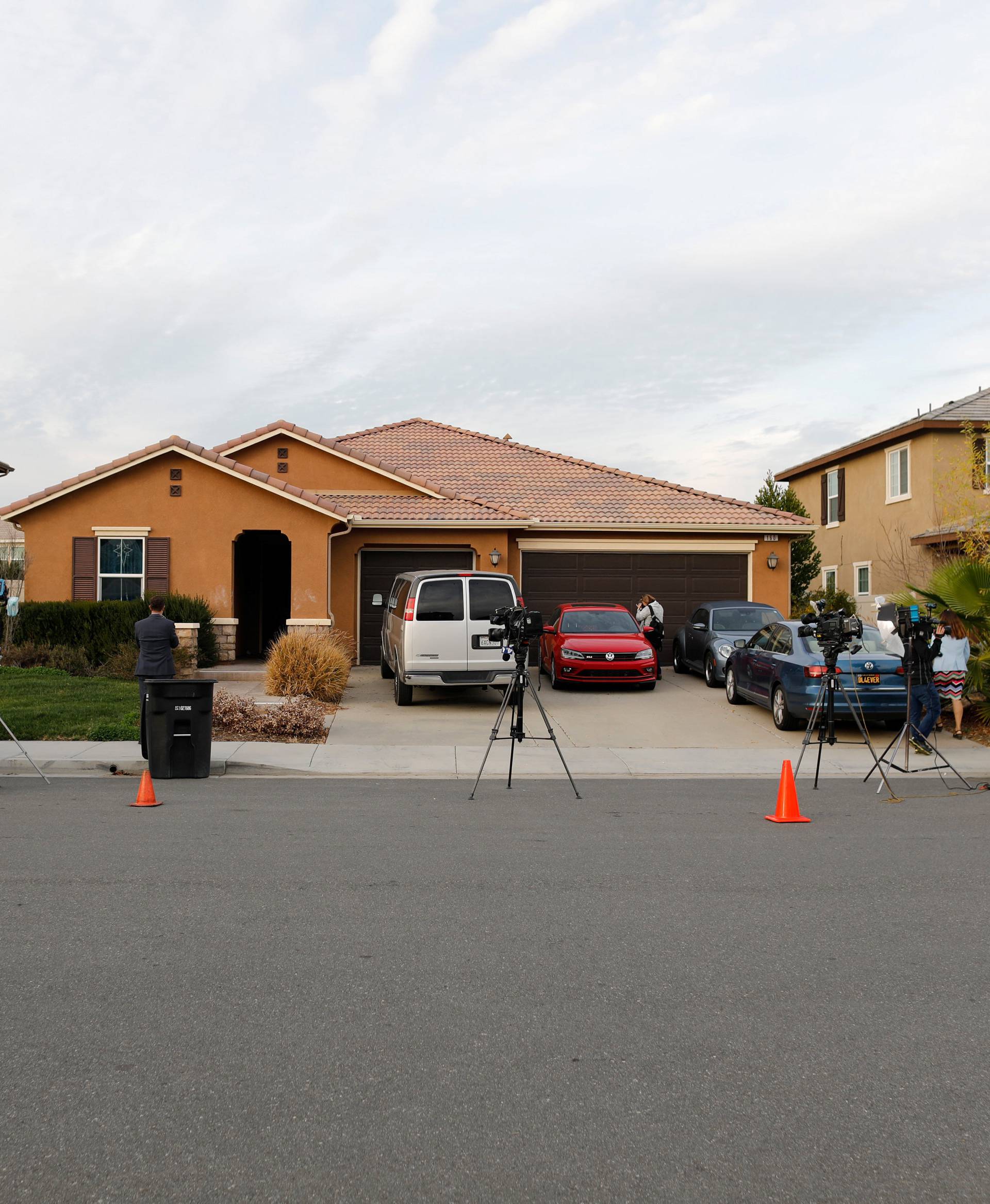 Members of the news media are parked outside the home of the Turpins in Perris