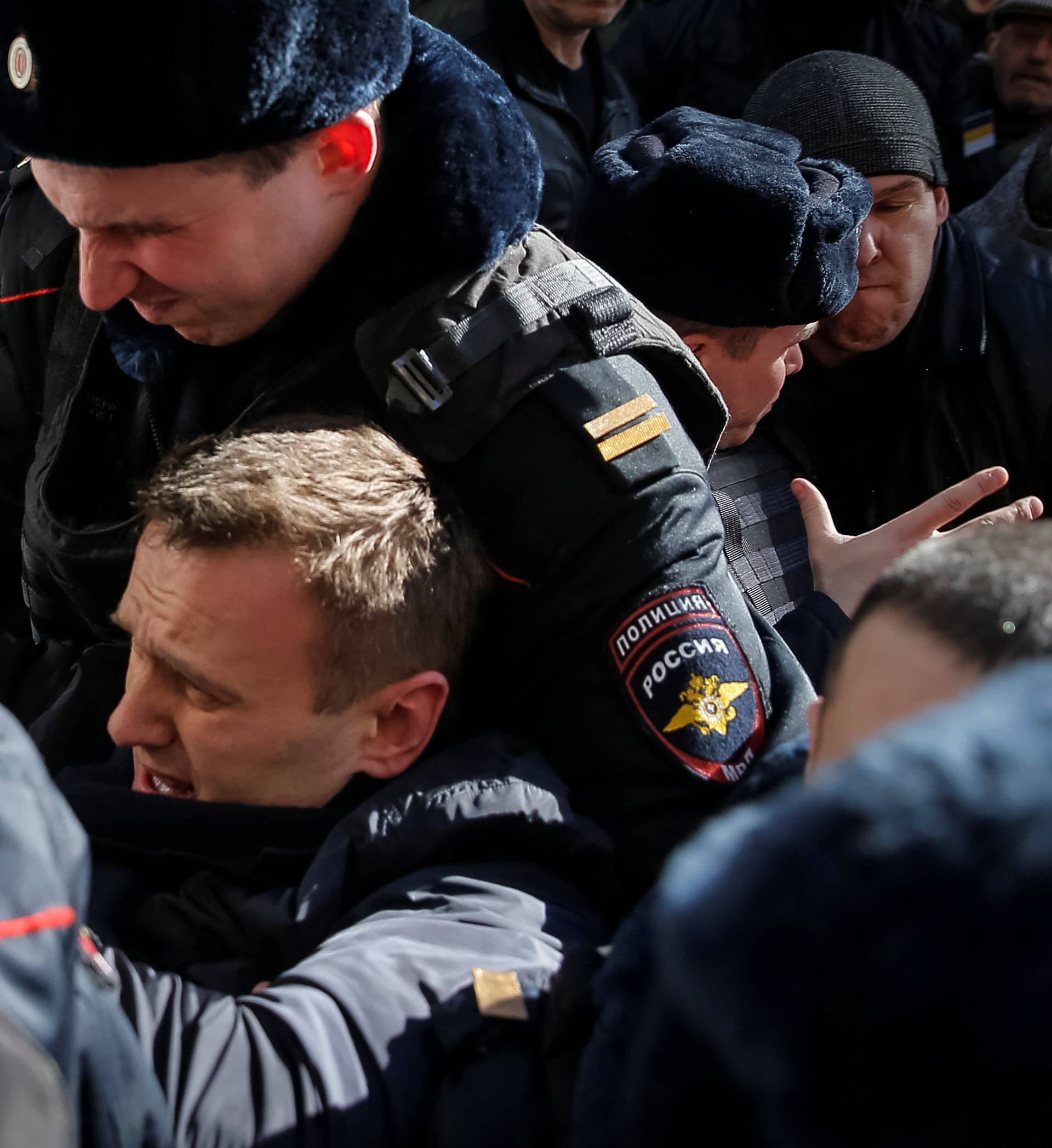 Police officers detain anti-corruption campaigner and opposition figure Alexei Navalny during a rally in Moscow, Russia