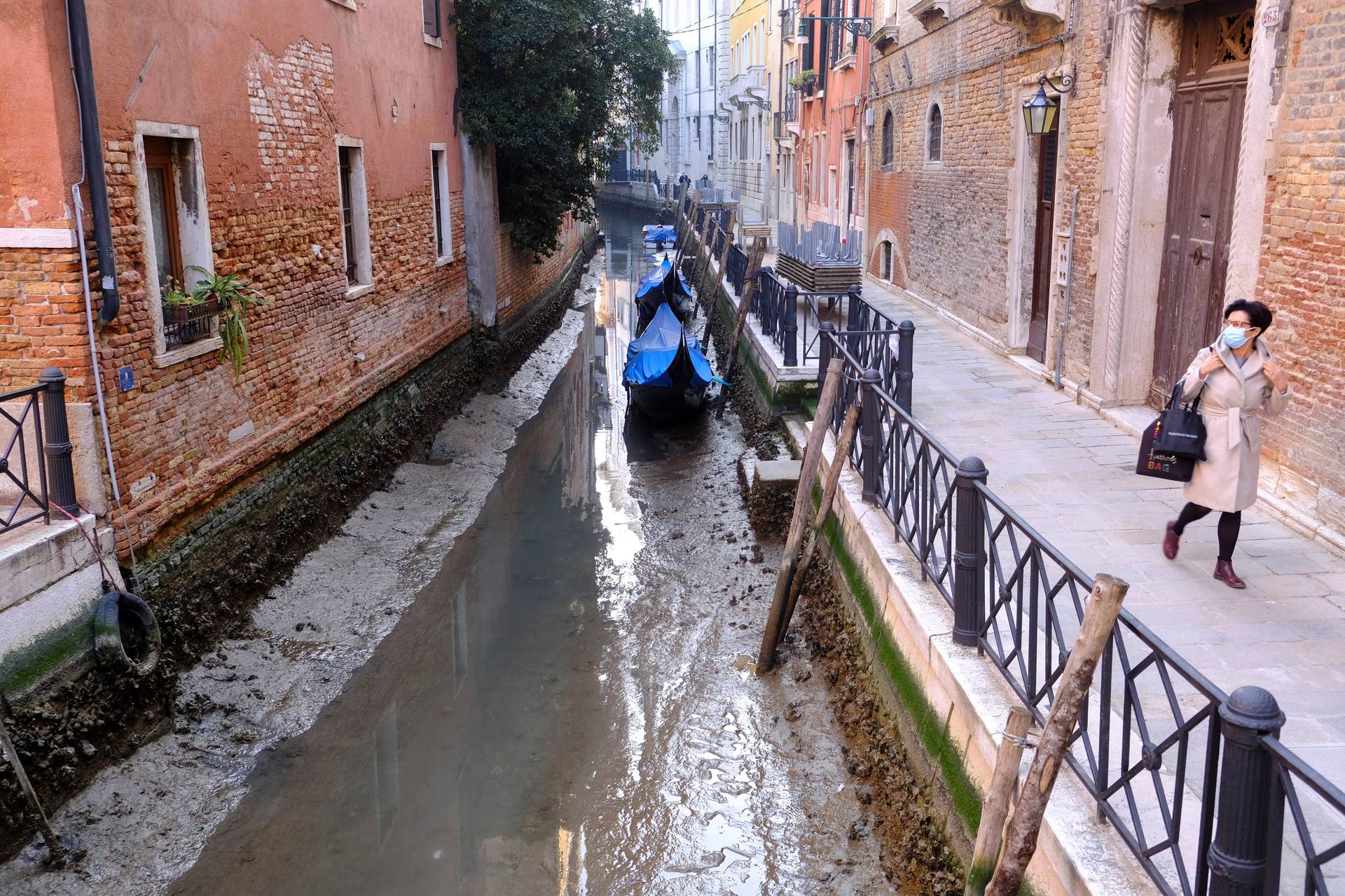 Gondolas are seen in a canal during an exceptionally low tide in the lagoon city of Venice