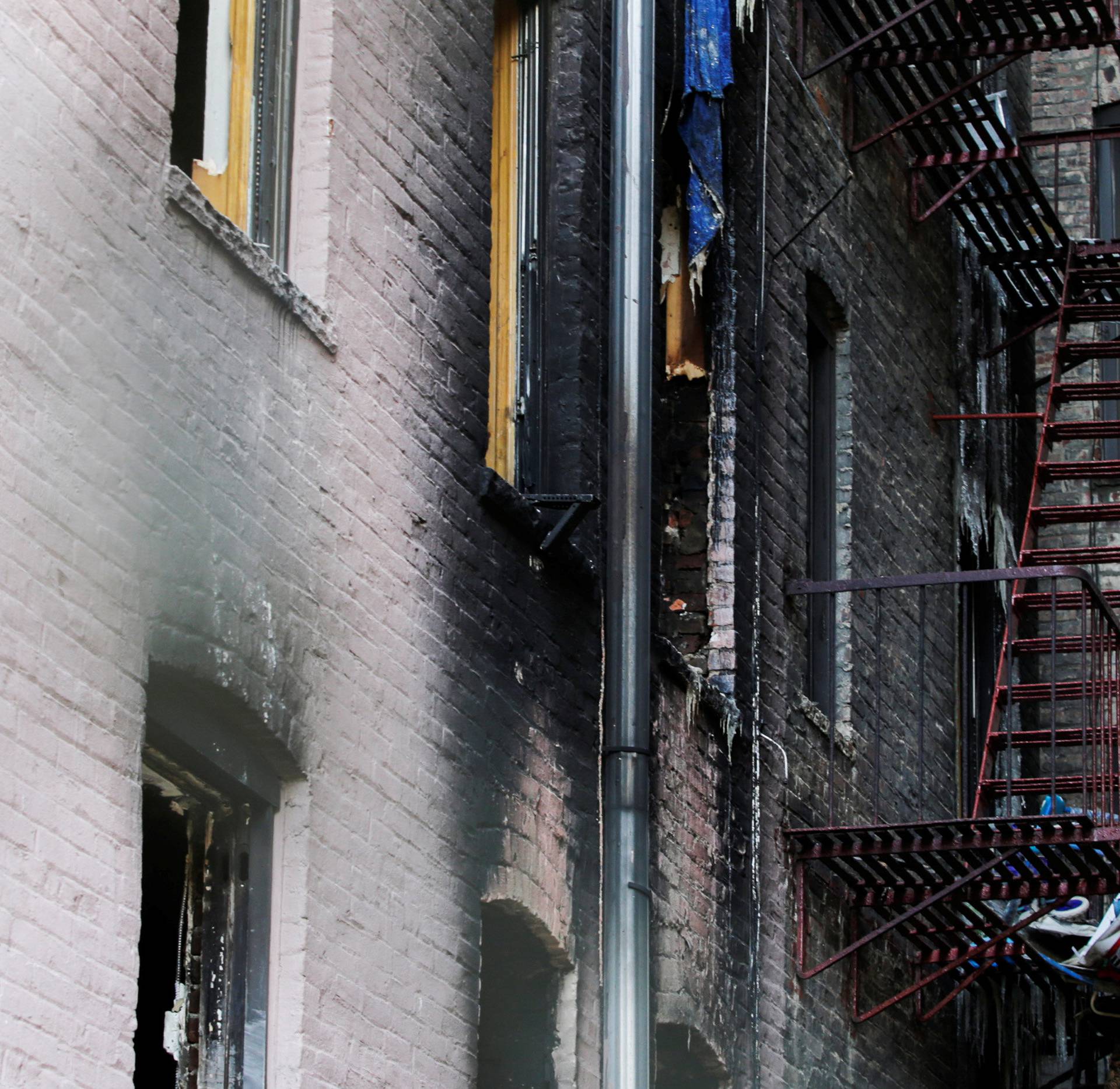 Windows of burned apartments are seen after a fire in a building in Bronx, New York