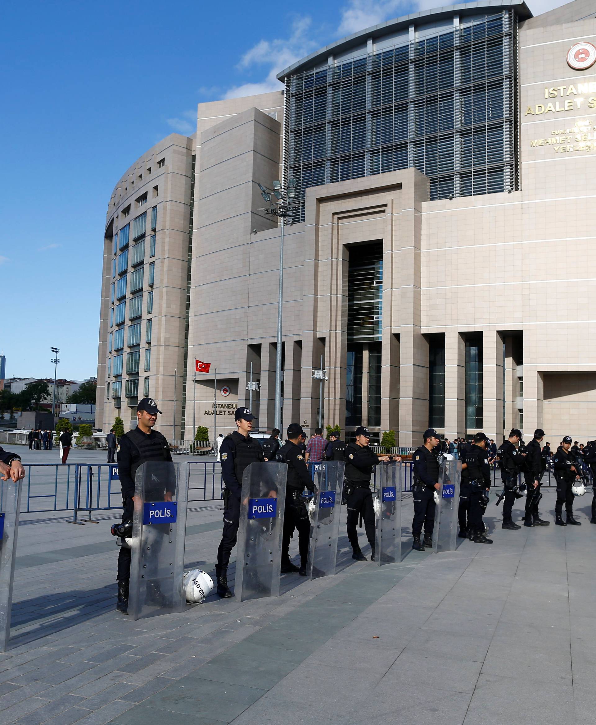 Turkish riot policemen secure the area after an attack aganist Can Dundar, editor-in-chief of Cumhuriyet in front of the Justice Palace in Istanbul
