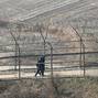 Paju, South Korea. 1st April 2014. South Korean soldiers patrol along the military fences near DMZ, Paju, South Korea, on Tuesday April 1, 2014. North and South Koreas exchanged artillery fire across the western maritime border, the Northern Limit Line (N